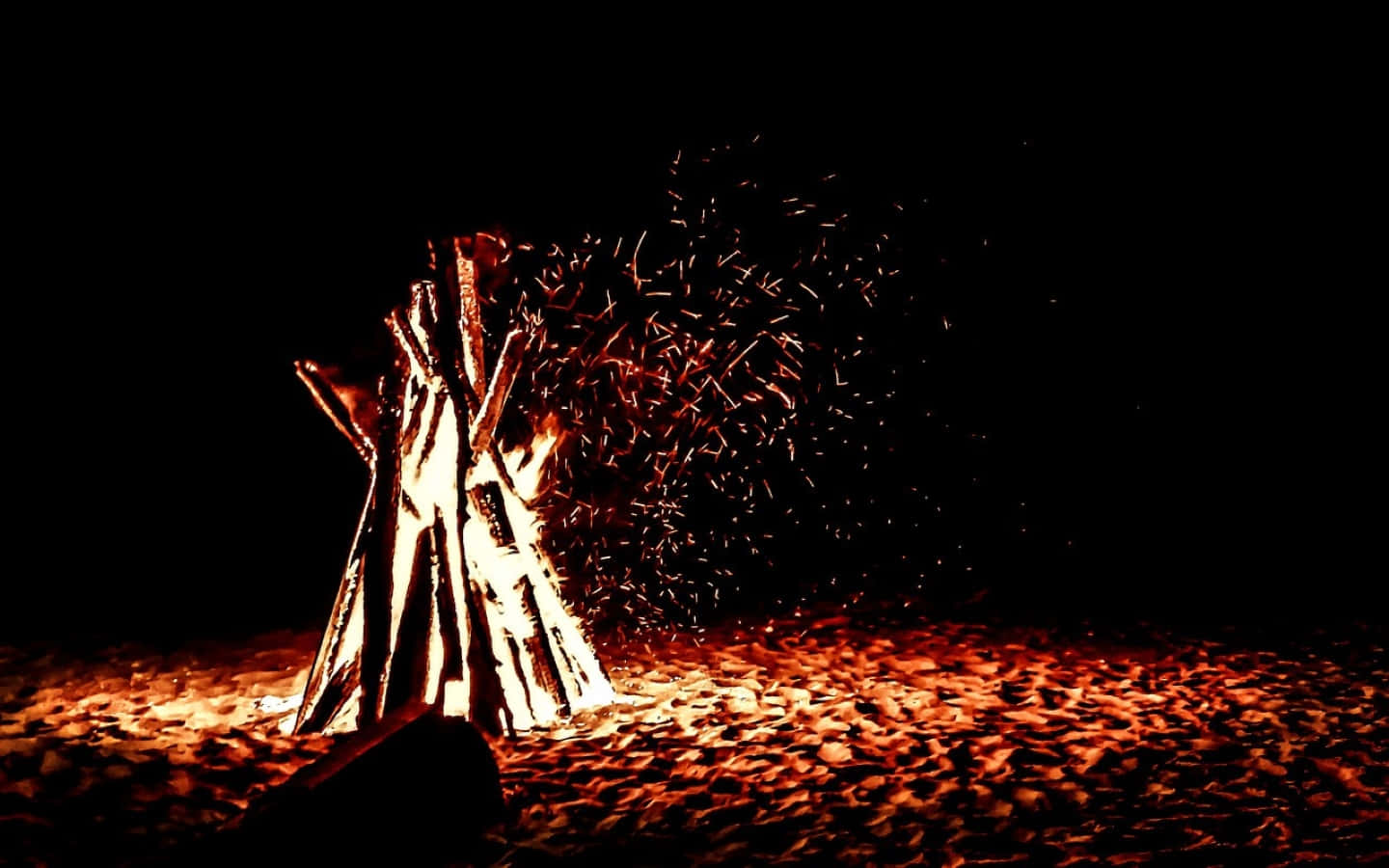 A Magical Bonfire Night On A Serene Beach Wallpaper