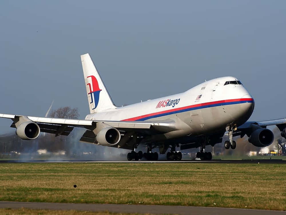 A Majestic Jumbo Jet Soaring Through The Sky Wallpaper