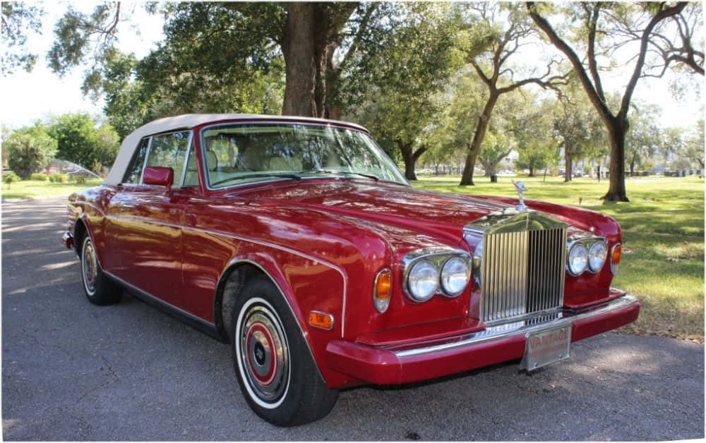 A Majestic Ride: The Rolls Royce Corniche Against A Breathtaking Sunset. Wallpaper