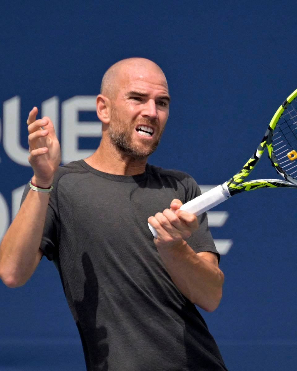 A Man Holding A Tennis Racket Wallpaper