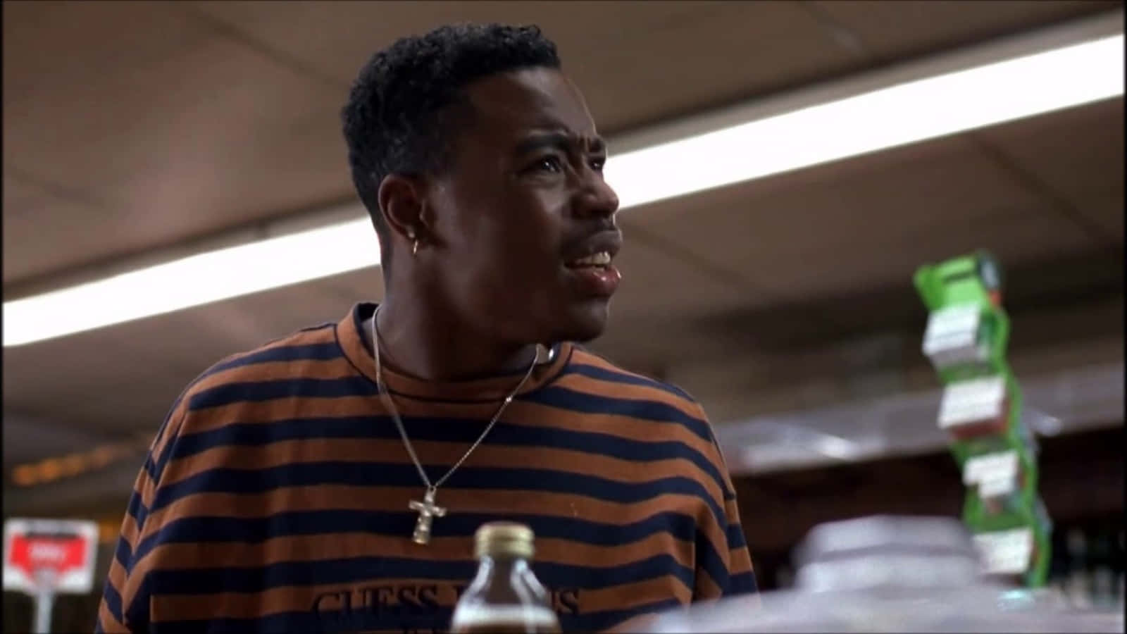 A Man In A Striped Shirt Standing In A Store Wallpaper