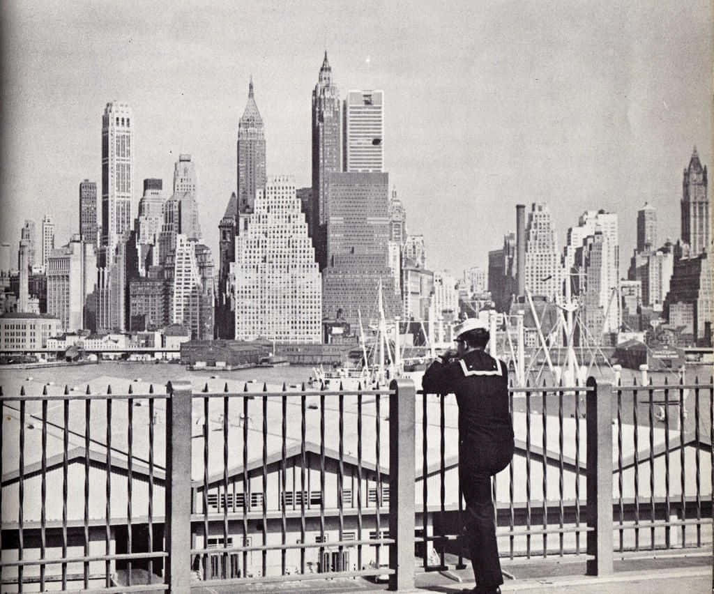 A Man In A Uniform Looking Out Over The City Wallpaper