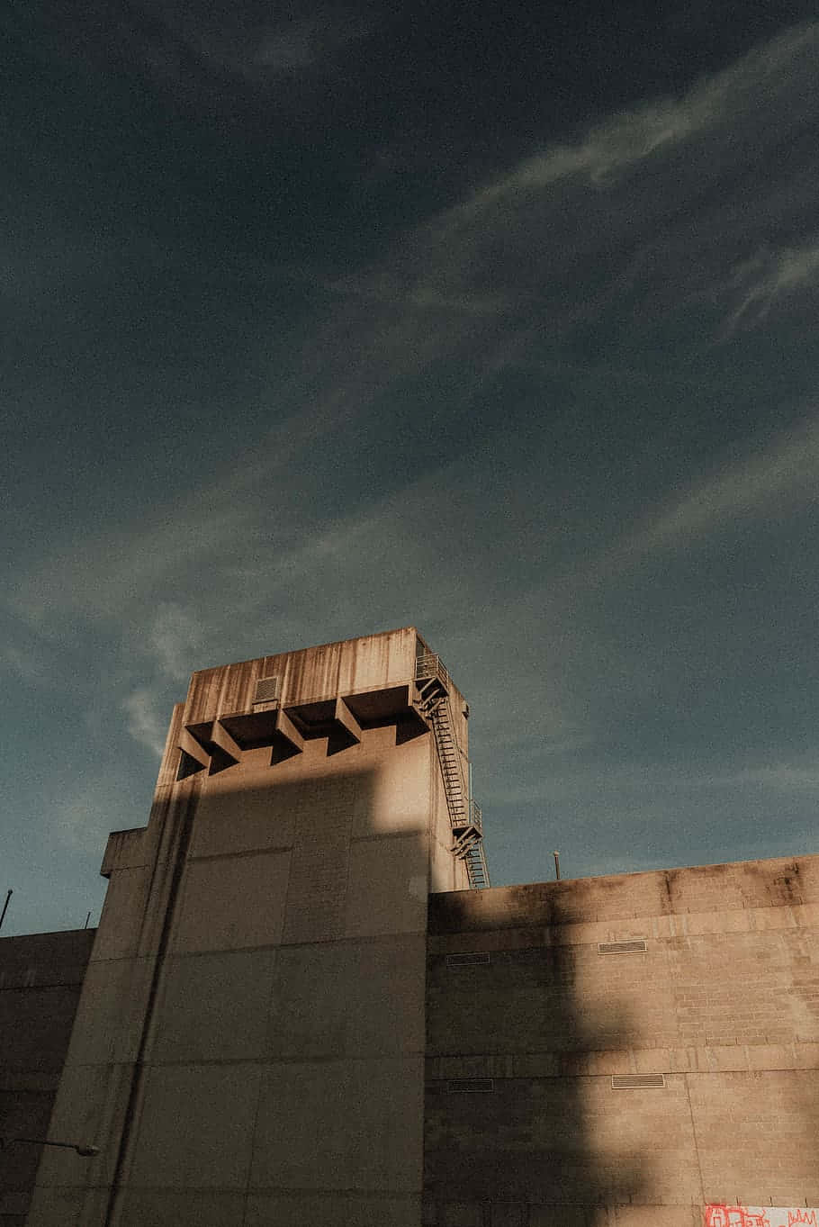 A Man Is Riding A Skateboard On A Concrete Wall Wallpaper