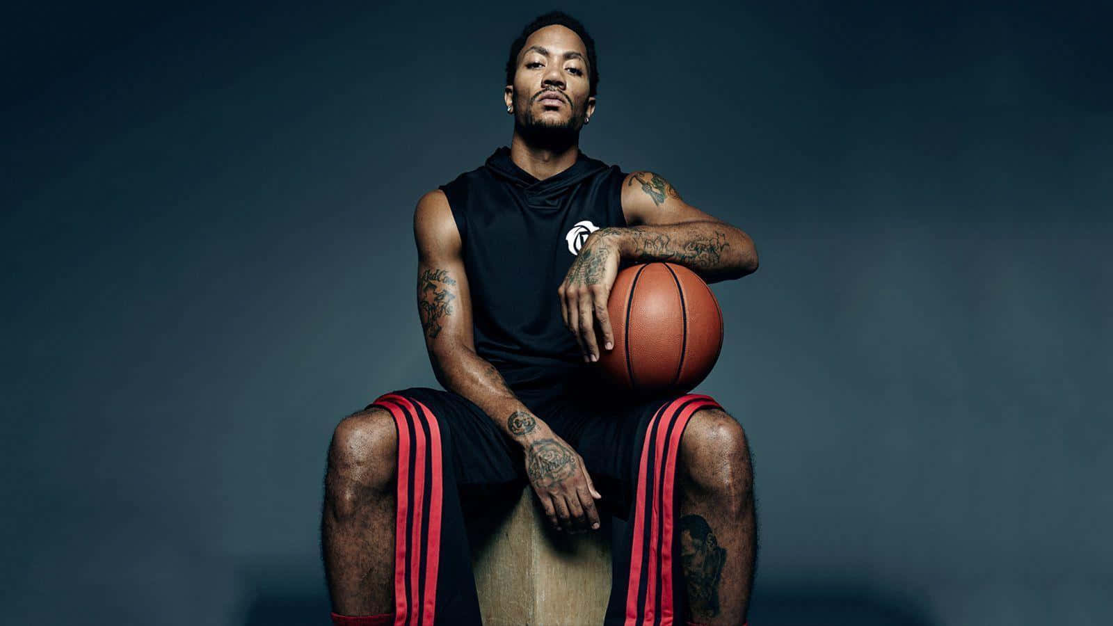 A Man Sitting On A Box Holding A Basketball Wallpaper