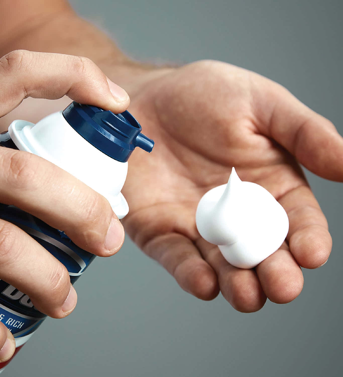 A Man Using Shaving Cream For A Close And Comfortable Shave Wallpaper