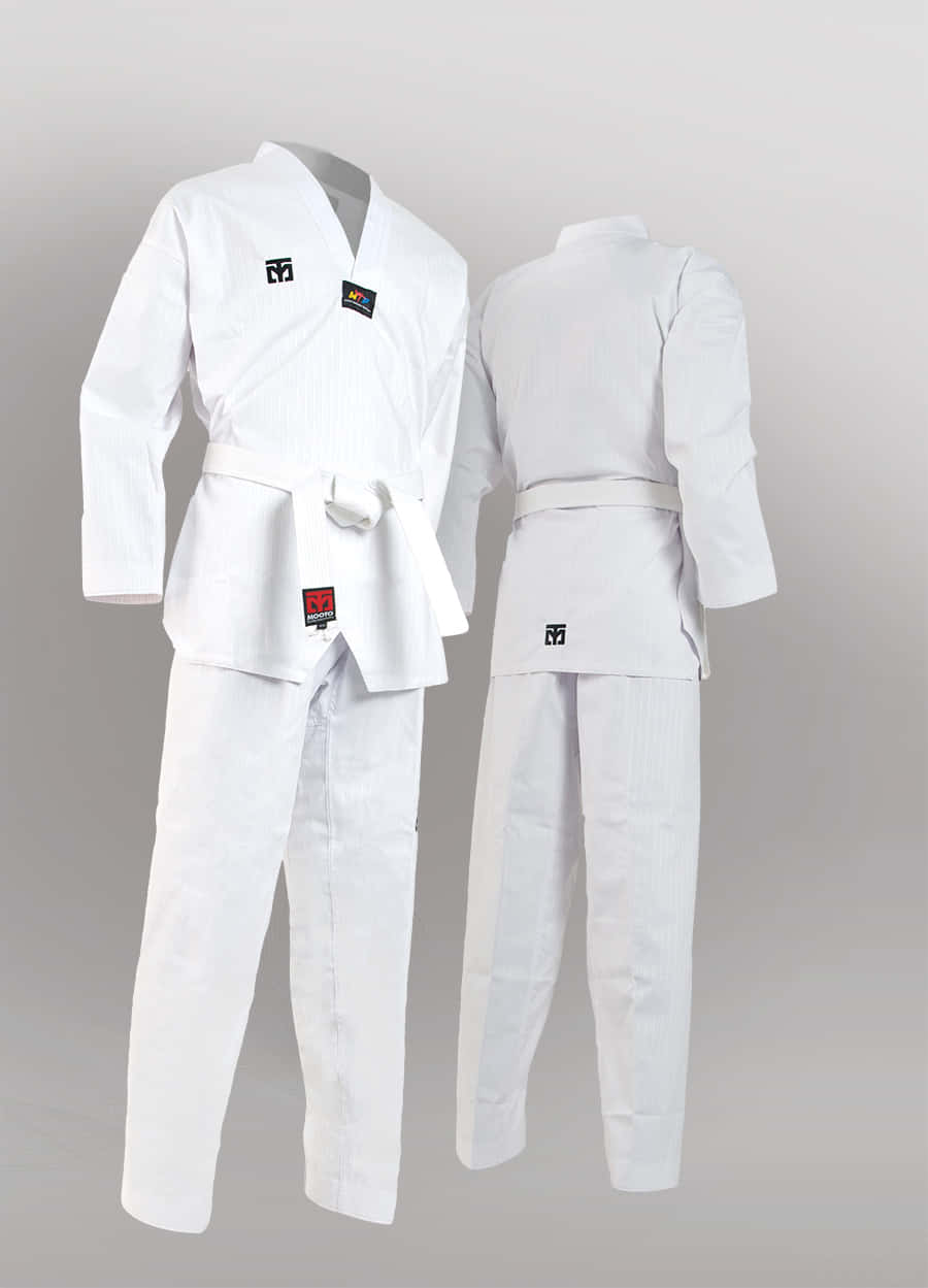 A Man Wearing White Taekwondo Uniform And Standing In Fighting Stance Wallpaper