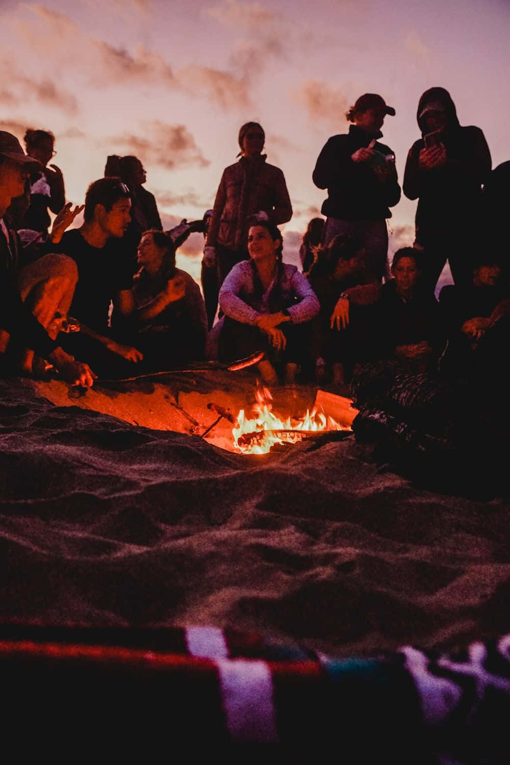 A Mesmerizing Beach Bonfire Under The Stars Wallpaper