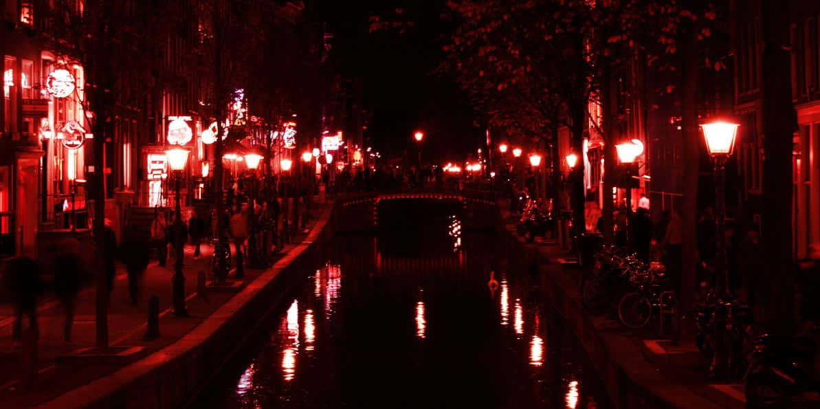 A Mesmerizing View Of Amsterdam's Red Light District At Night Wallpaper