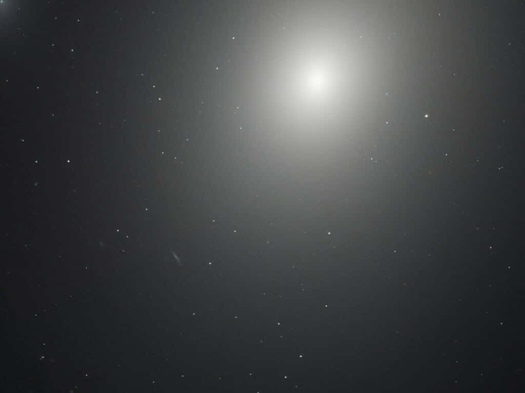 A Mesmerizing View Of An Elliptical Galaxy In Deep Space Wallpaper