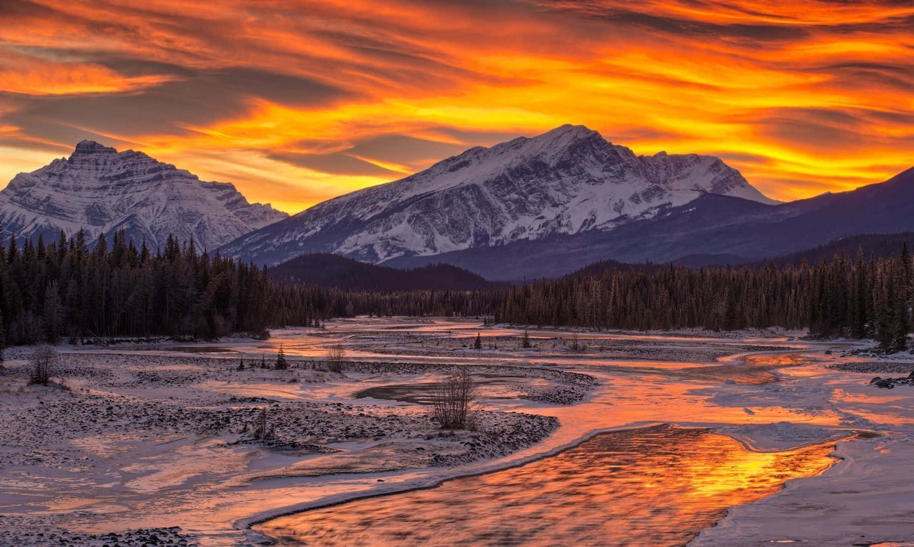 A Mesmerizing Winter Sun Shining Brightly Over A Snow-covered Landscape Wallpaper