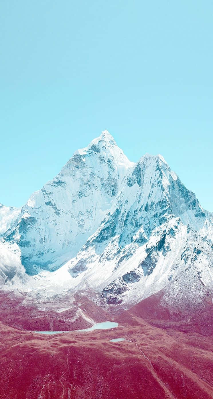 A Mountain Covered In Snow With A Pink Sky Wallpaper