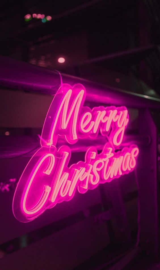 A Neon Sign With The Word Merry Christmas Wallpaper