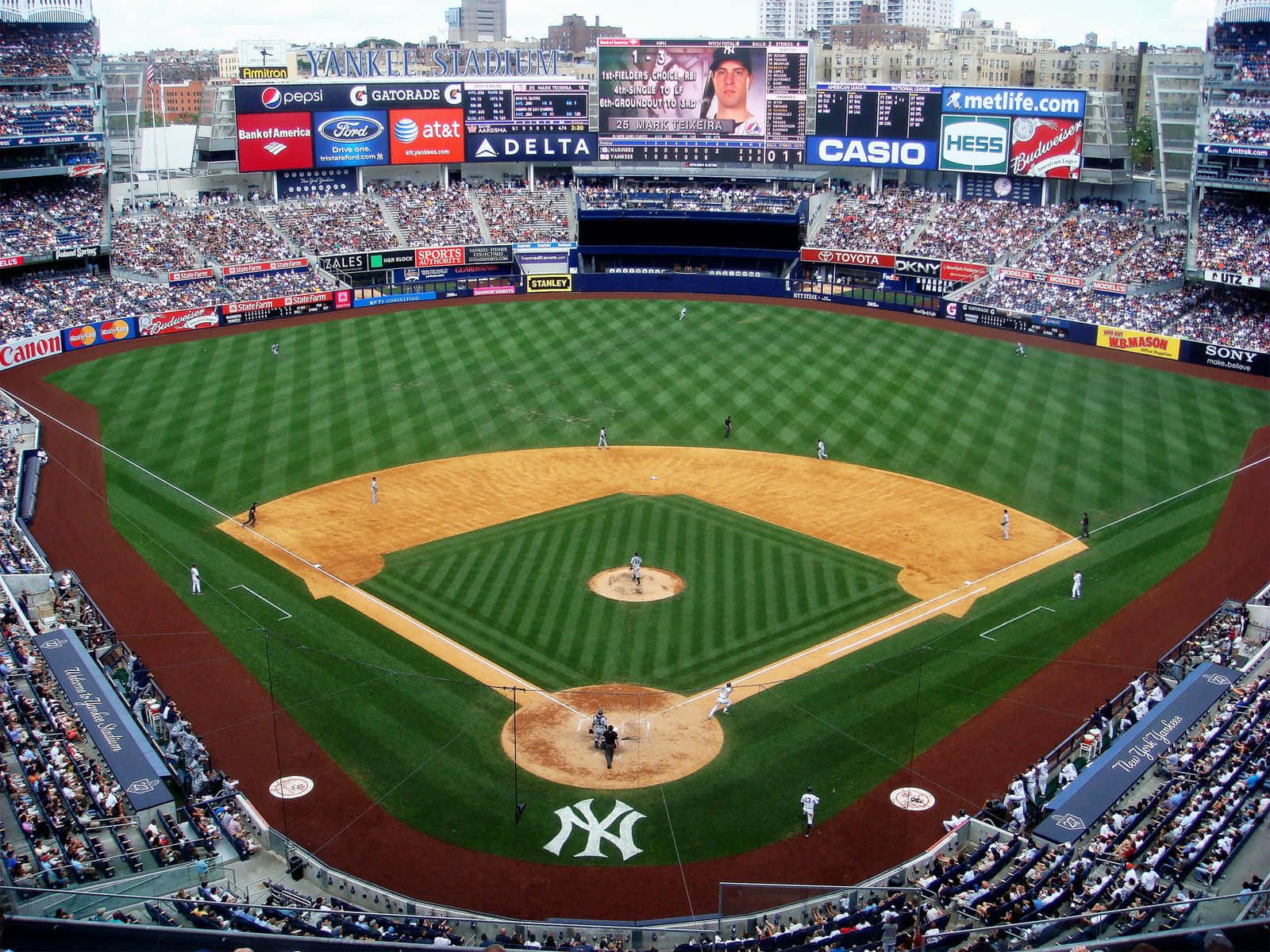 A Packed Baseball Stadium Under Bright Lights Wallpaper