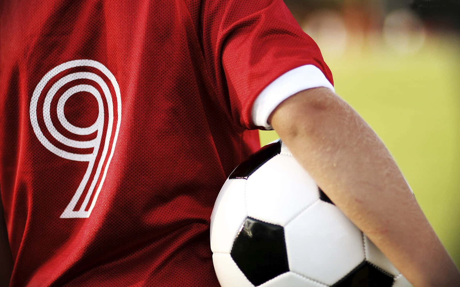 A Person Holding A Soccer Ball Wallpaper