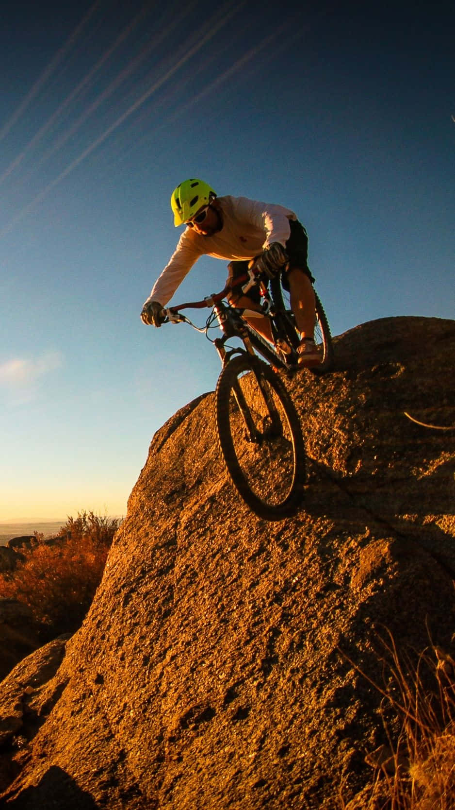 A Person Riding A Mountain Bike On A Rock Wallpaper