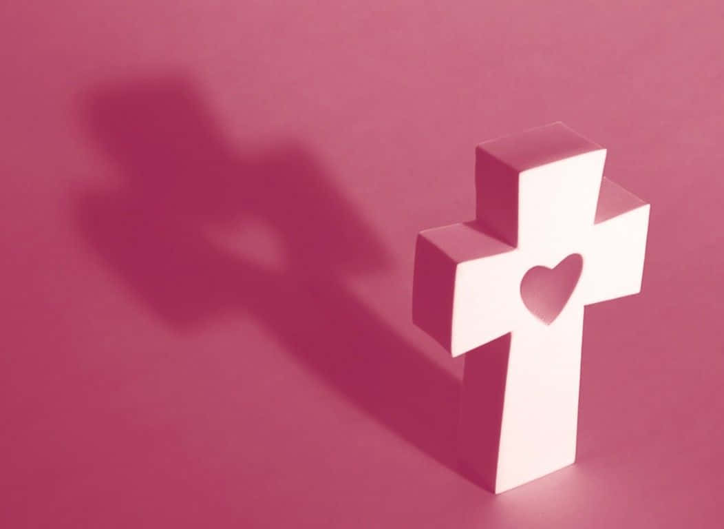 A Pink Cross Reminding Of Hope, Healing And Faith Wallpaper