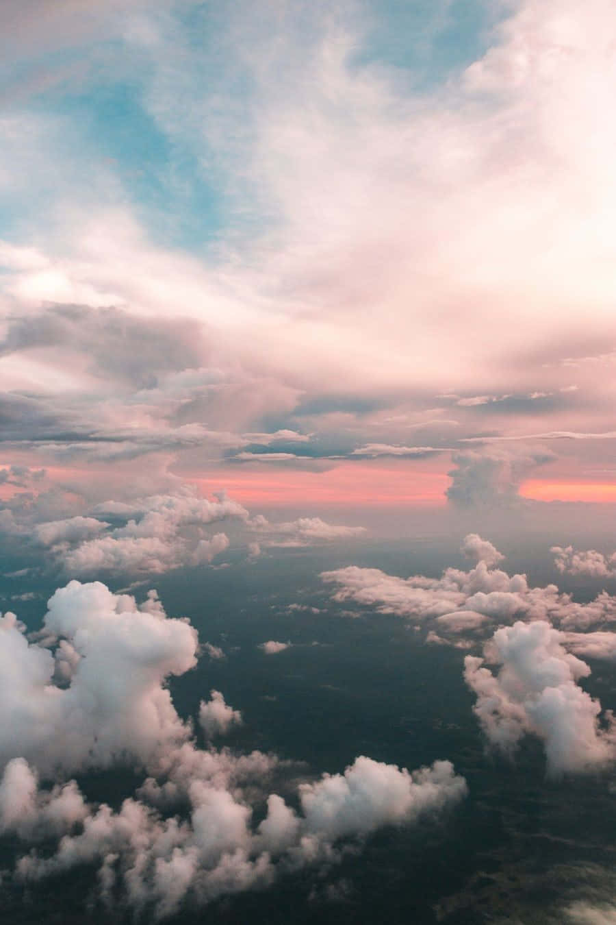 A Plane Flying Over The Clouds Wallpaper