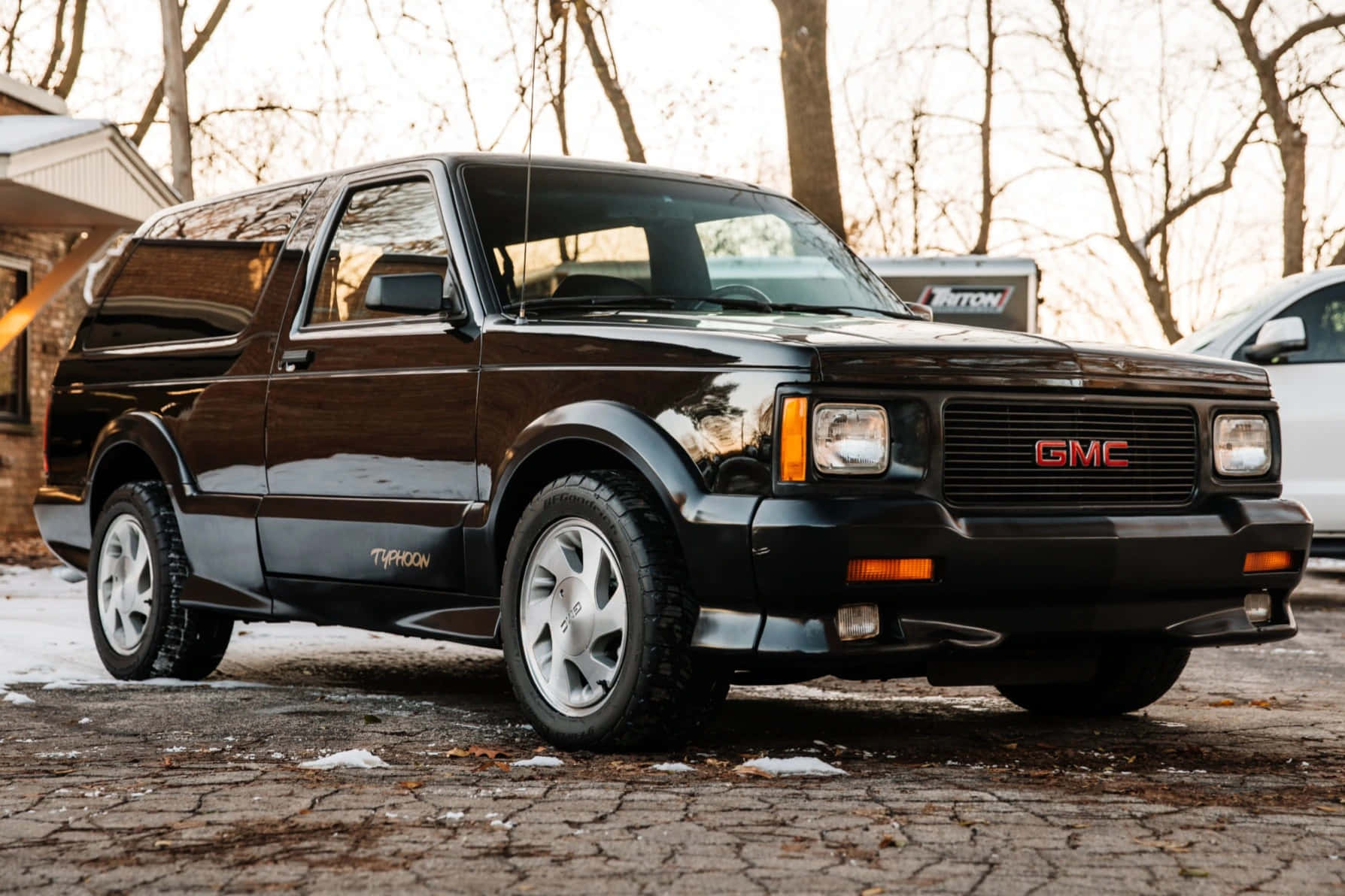 A Powerful Gmc Typhoon Taking Over The Road Wallpaper