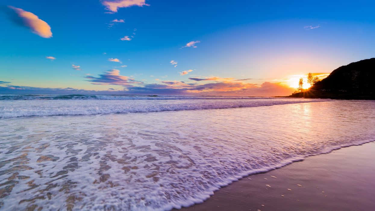 A Pristine Australian Beach With Turquoise Waters And Soft White Sand Wallpaper