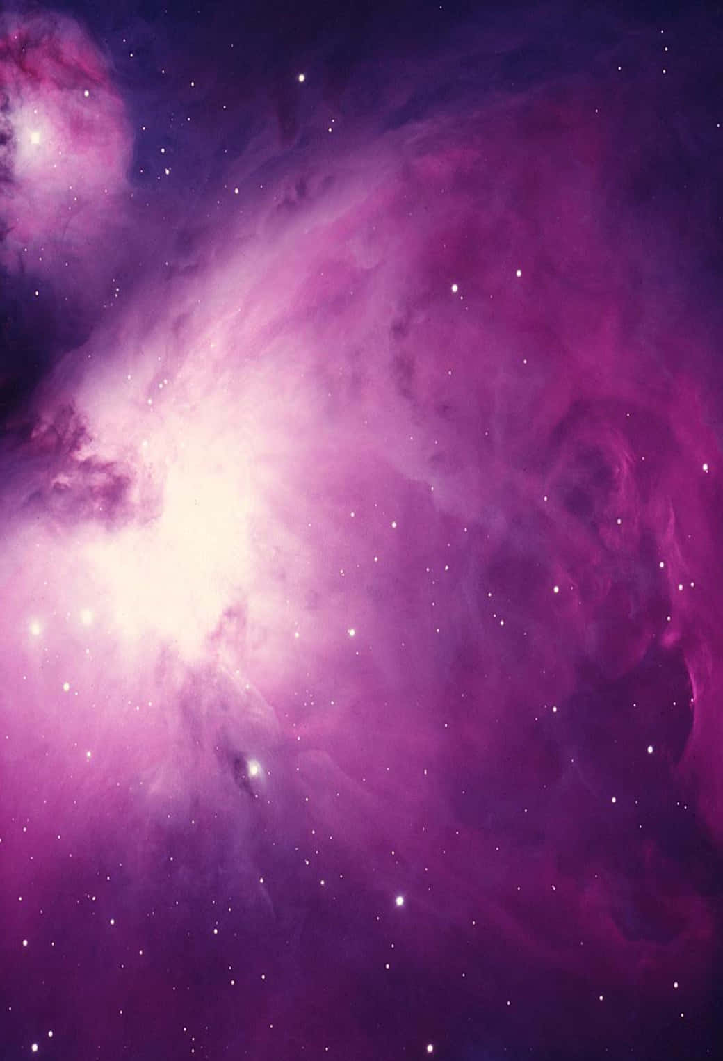 A Purple Nebula With Stars In The Background Wallpaper