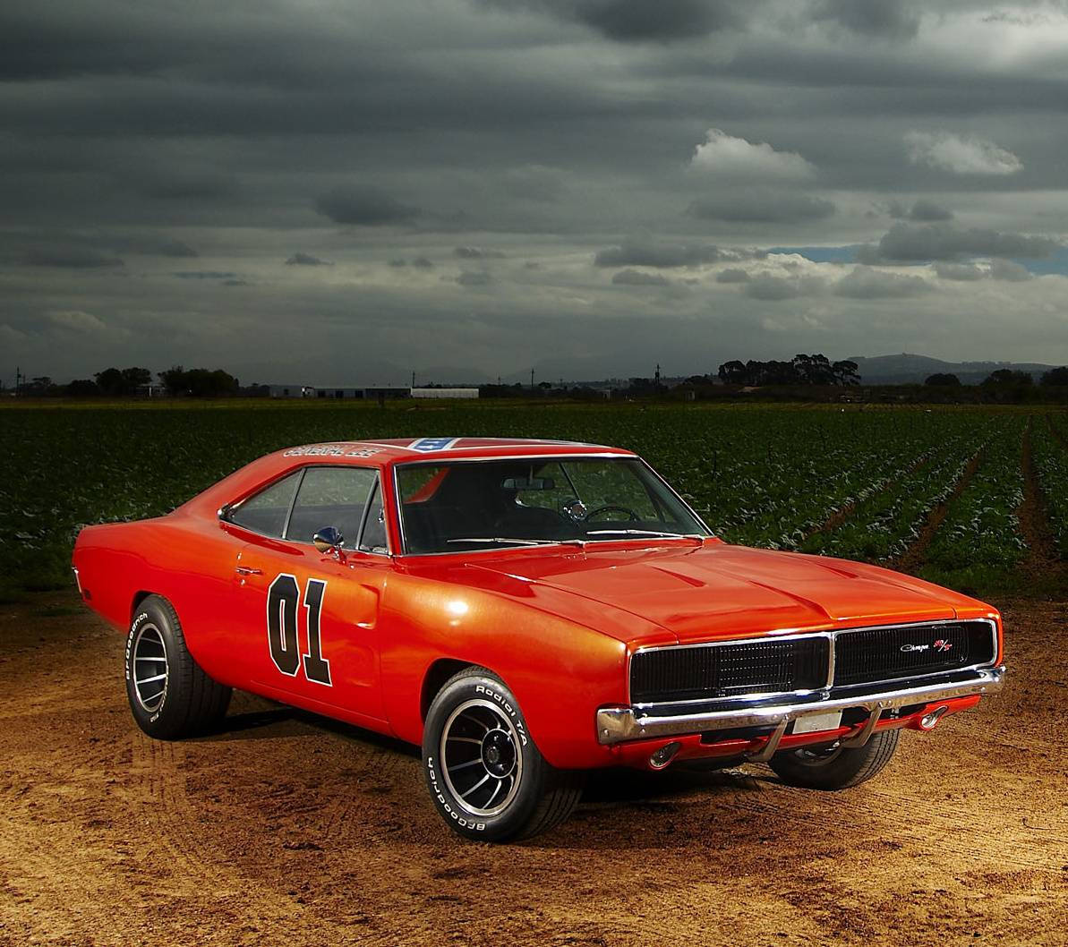 A Red Car Parked On A Dirt Road Wallpaper