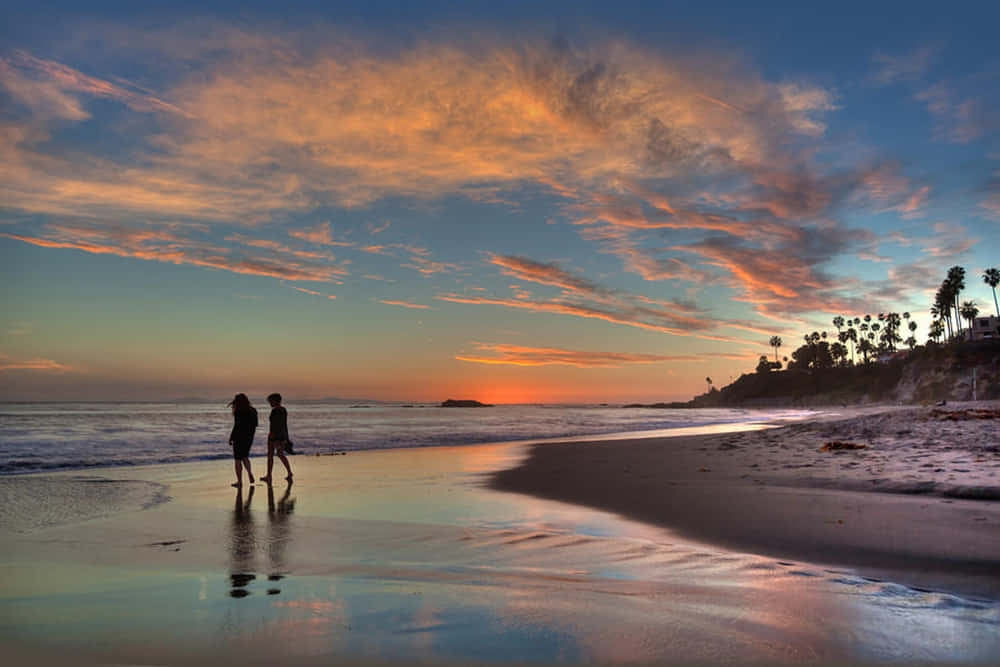 A Relaxing Walk Along The Sandy Beach Wallpaper