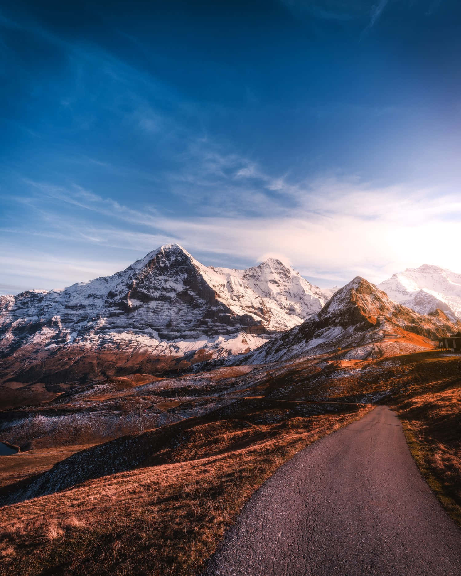 A Road Leading To The Mountains In The Alps Wallpaper