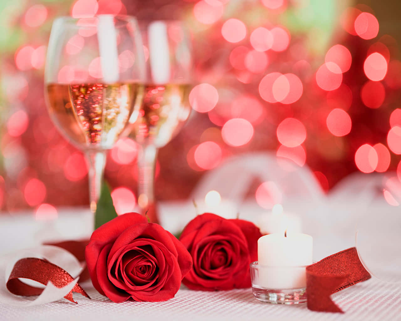 A Set Of Champagne Flutes Filled With Pink Champagne Alongside A Bottle Wallpaper