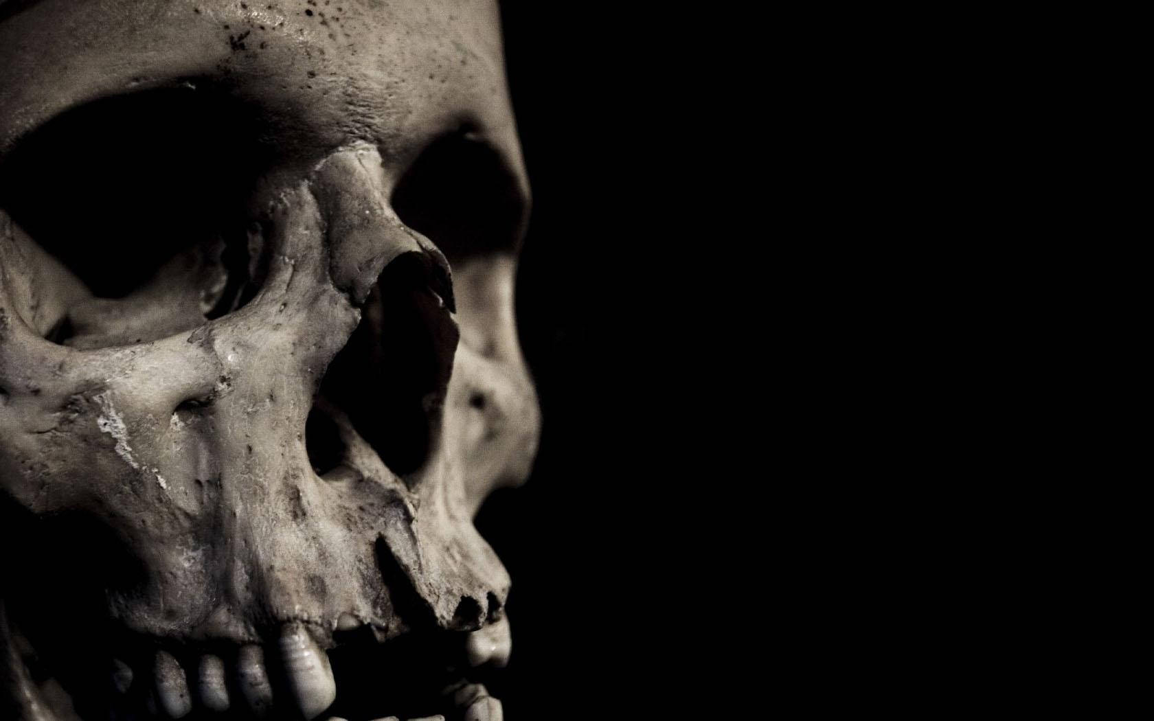 A Skull With Teeth On A Black Background Wallpaper