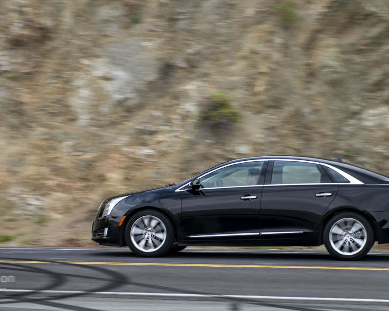 A Sleek, Black Cadillac Xts In An Urban Setting Showcasing Its Modern Design And Luxurious Appeal. Wallpaper