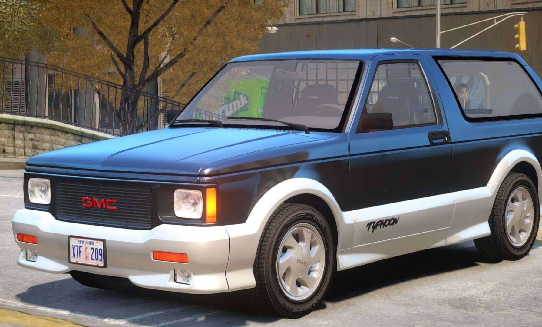 A Sleek, Black Gmc Typhoon Parked On A Sunlit Street Wallpaper