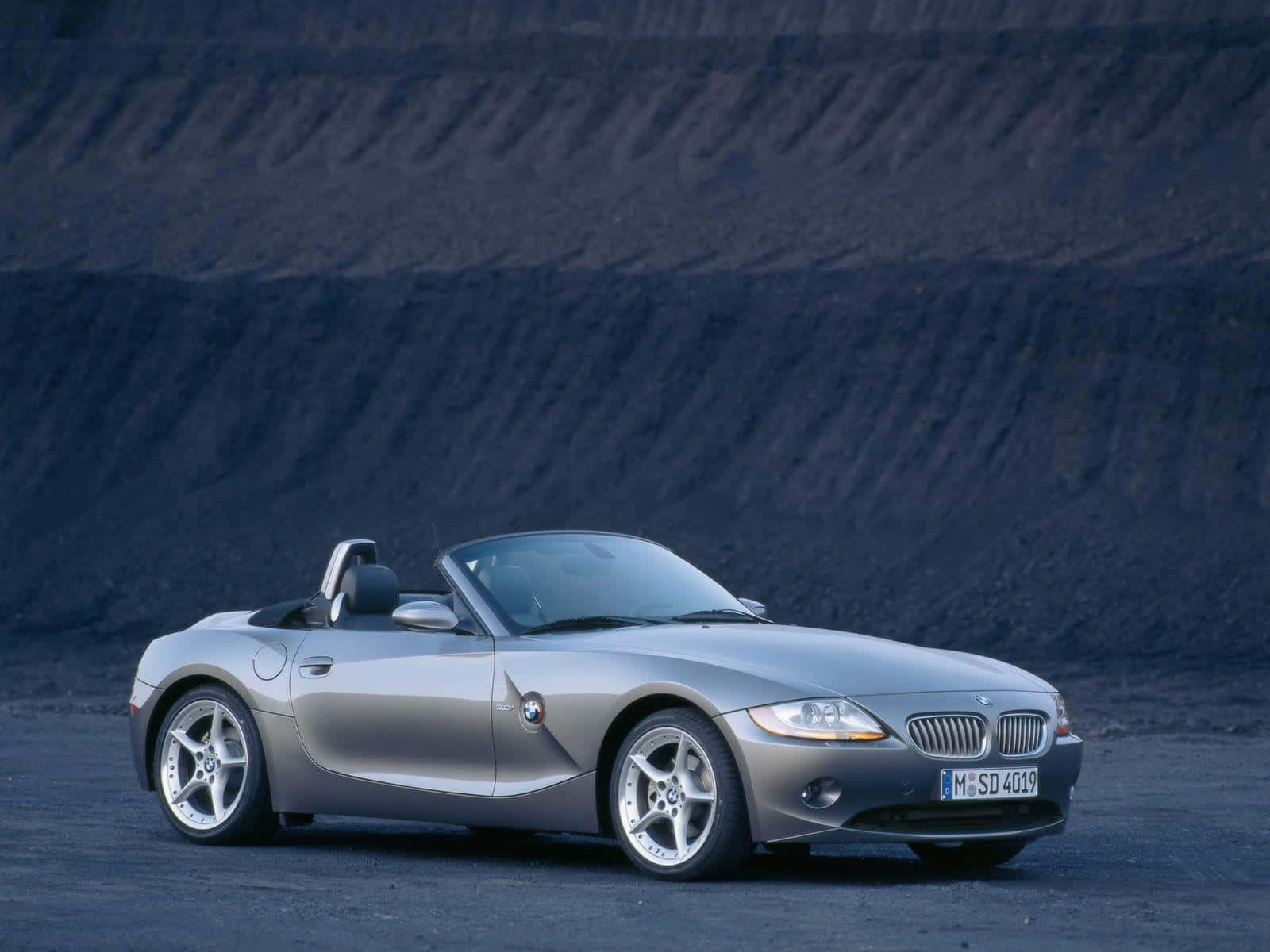 A Sleek Bmw Z4 Convertible On The Road Wallpaper