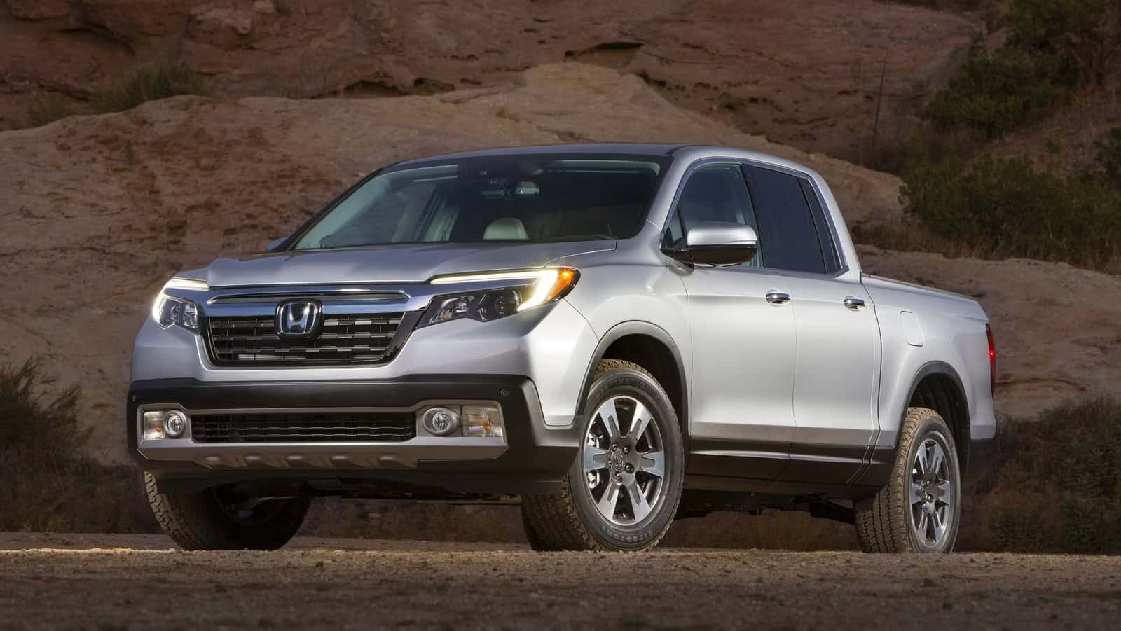 A Sleek Honda Ridgeline Cruising Down A Scenic Road Wallpaper