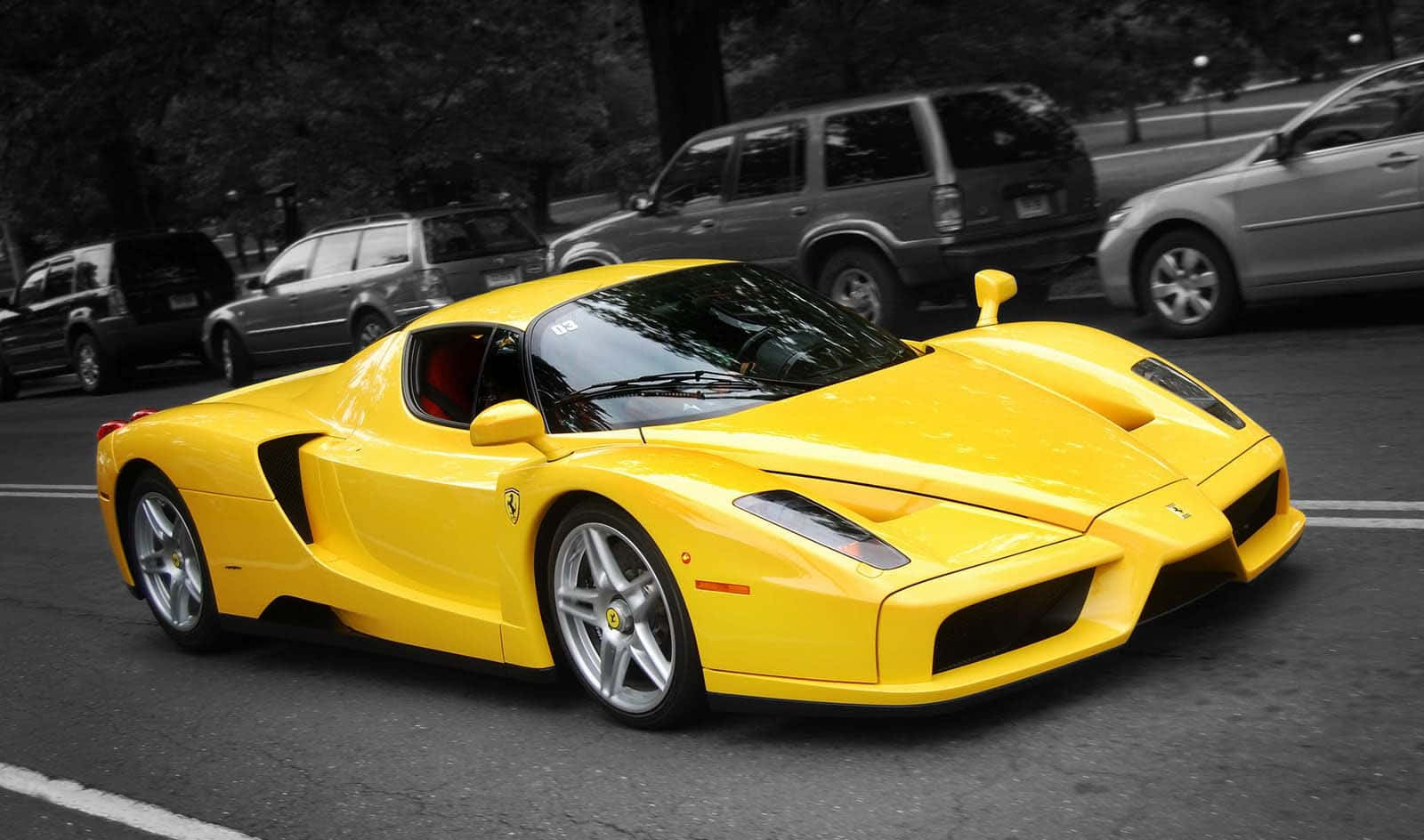 A Sleek Red Ferrari Enzo On An Open Road Wallpaper