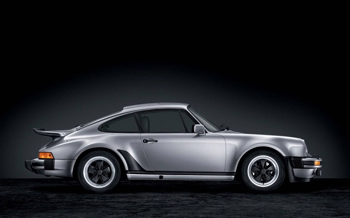 A Sleek Silver Porsche 911 With Black Accents Wallpaper