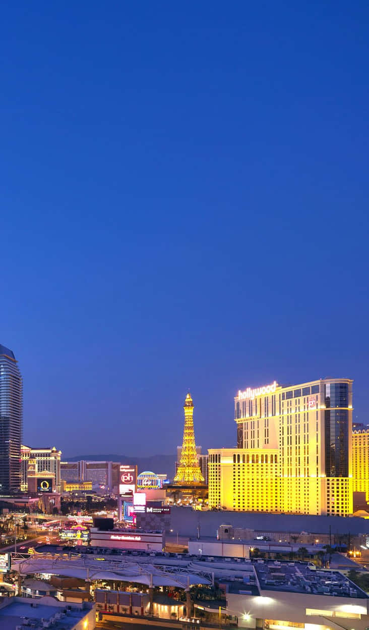 A Smartphone In Front Of The Stunning Las Vegas Skyline Wallpaper