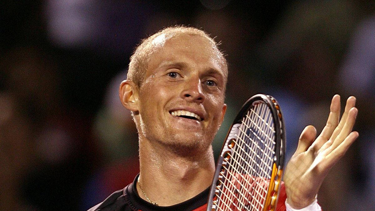 A Smiling Nikolay Davydenko During A Tennis Match Wallpaper