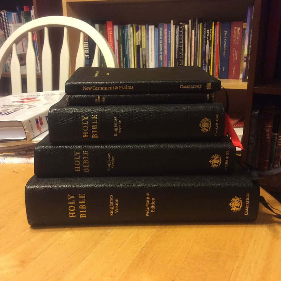 A Stack Of Books On A Table Wallpaper