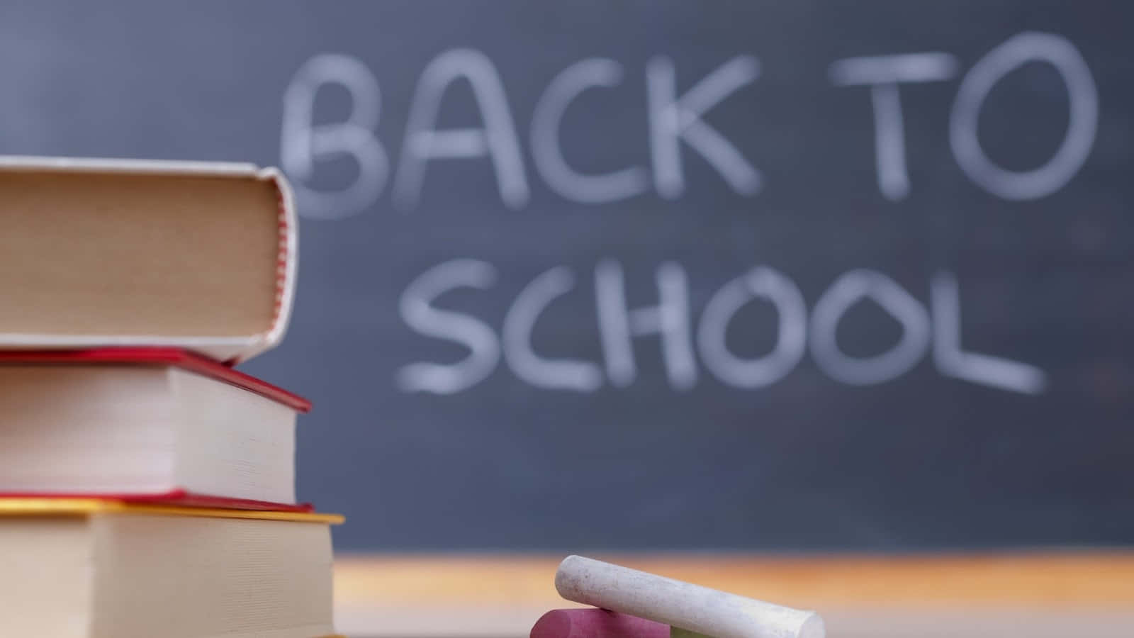 A Stack Of Books With The Word Back To School Written On Them Wallpaper