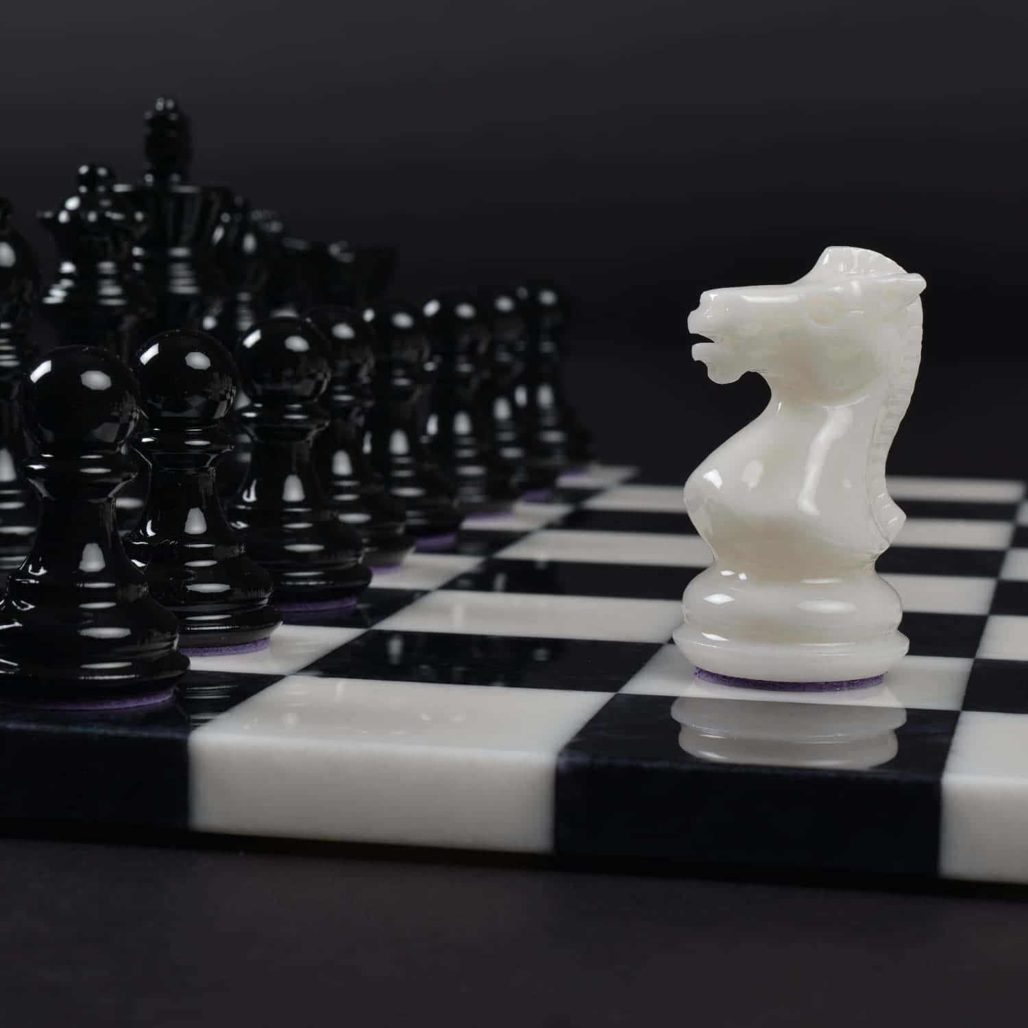 A Strategic Game Of Black And White Chess Pieces On A Beautiful Chessboard Wallpaper