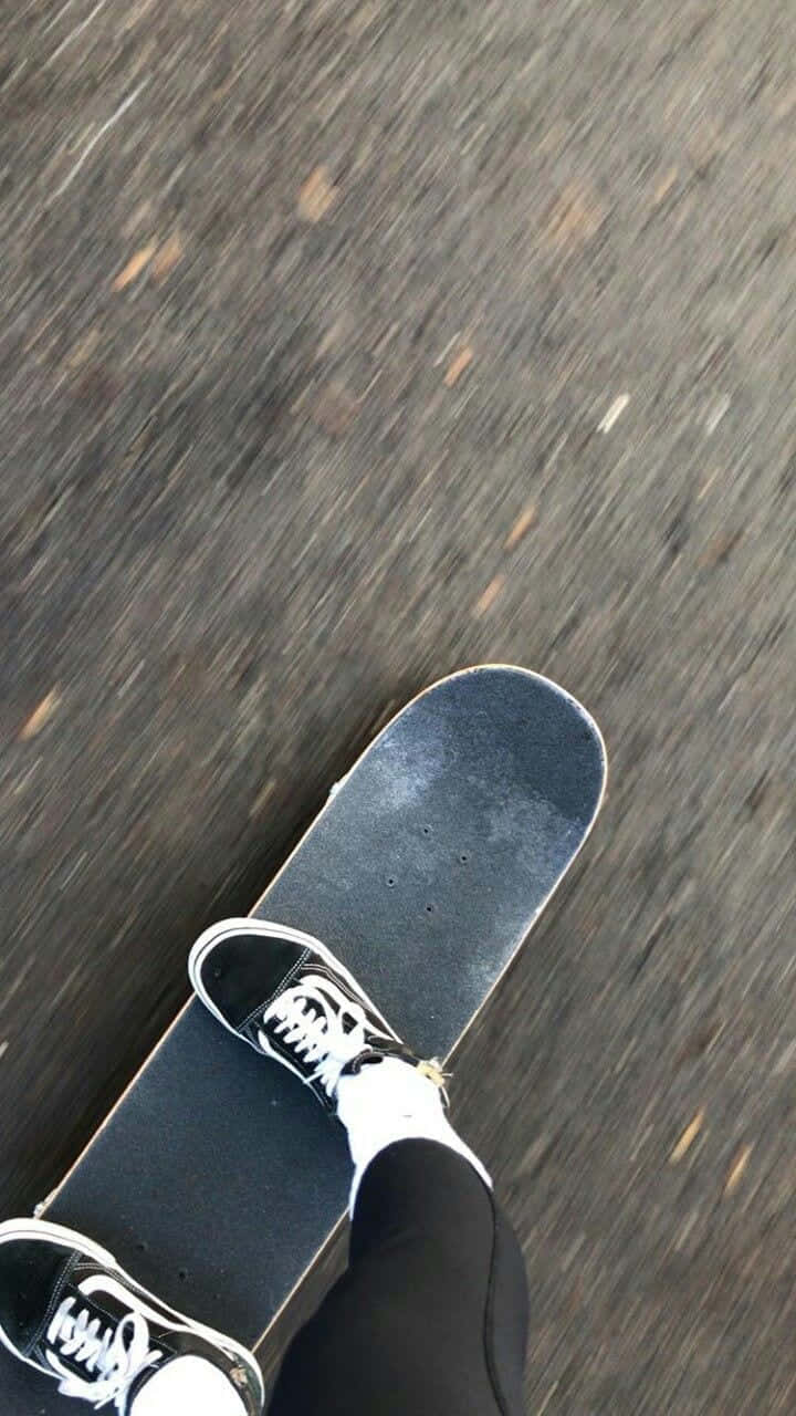 A Street Skater Doing An Impressive Tricks On A Street Rail Wallpaper