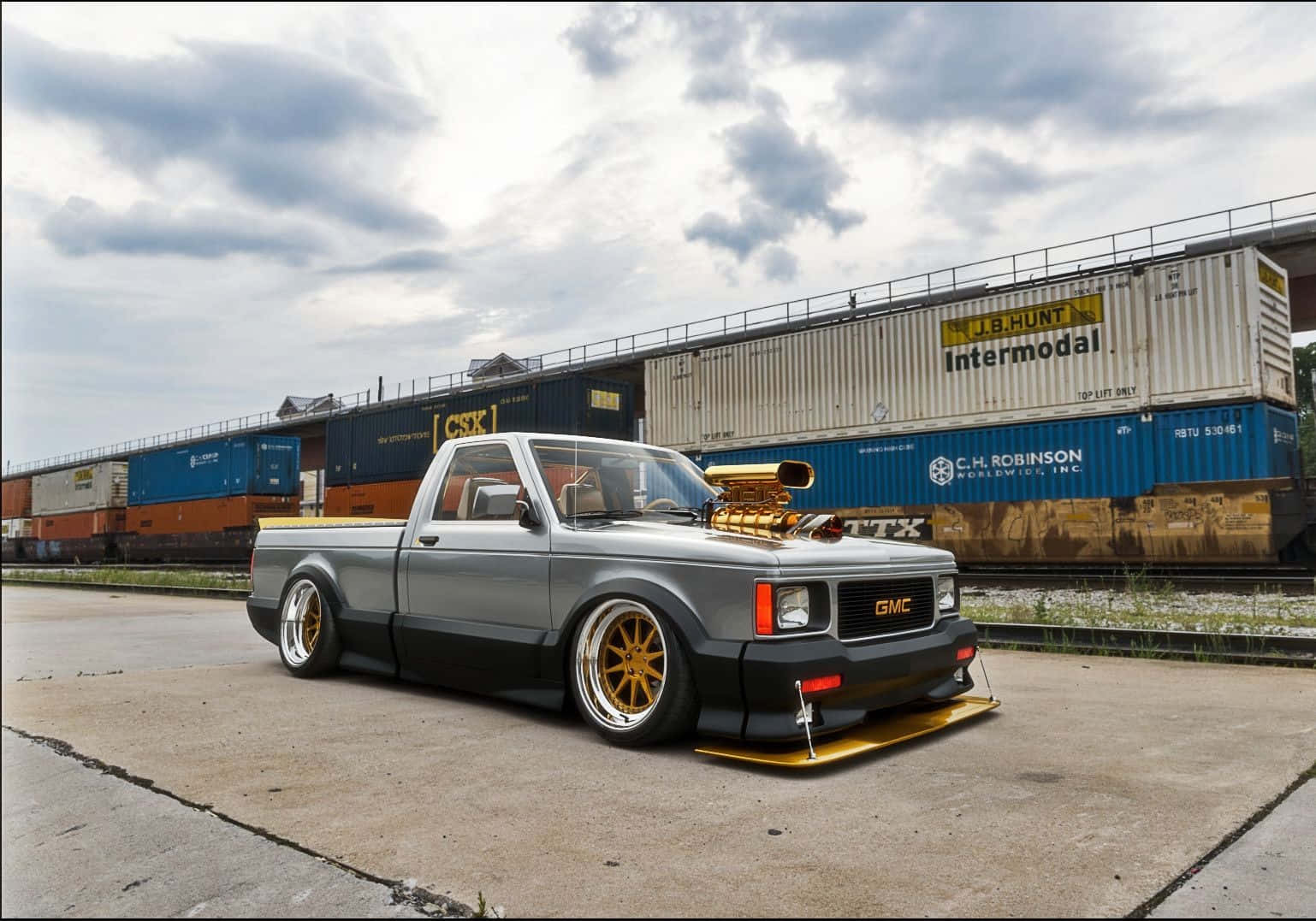 A Stunning Black Gmc Syclone Against A Picturesque Backdrop. Wallpaper