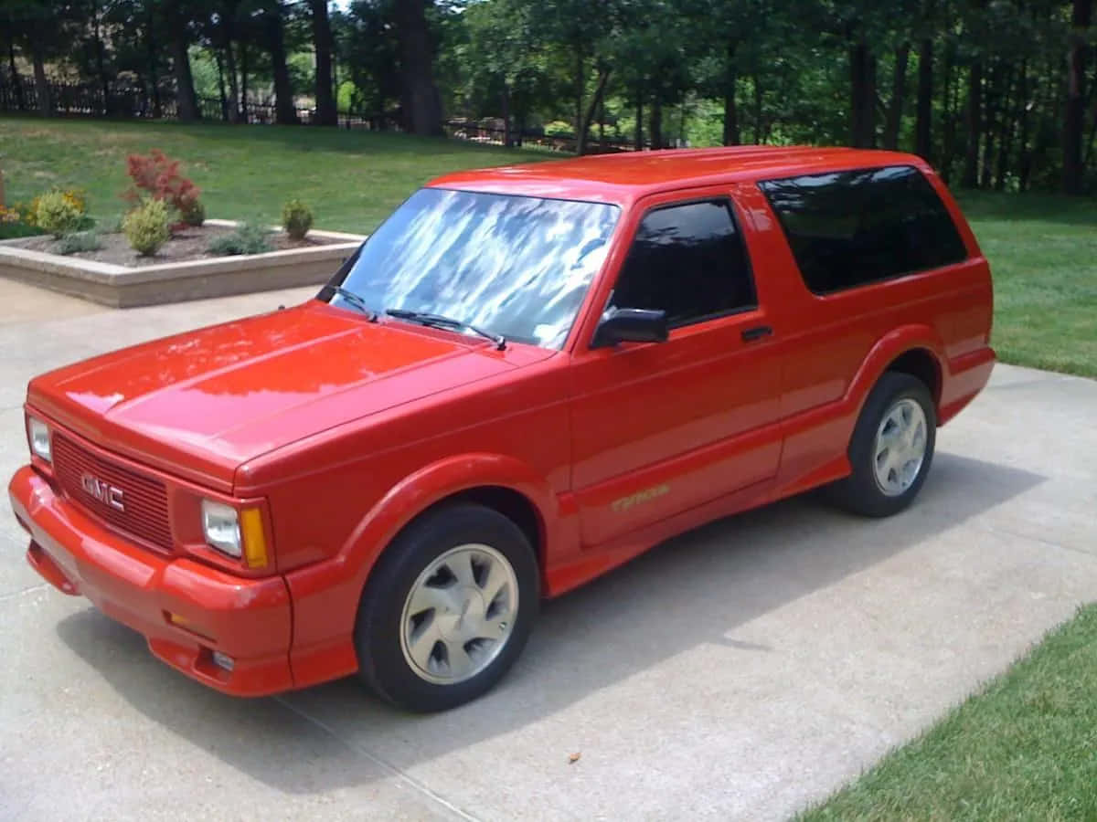 A Stunning Gmc Typhoon Parked Outdoors Wallpaper