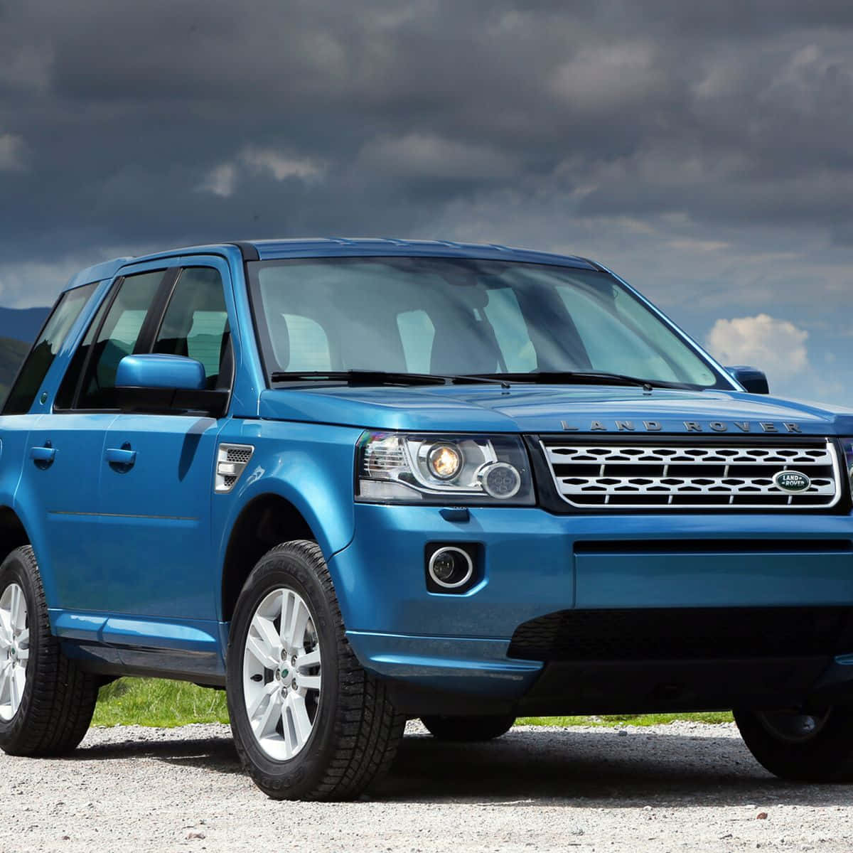 A Stunning Land Rover Freelander In Motion On A Dirt Road. Wallpaper