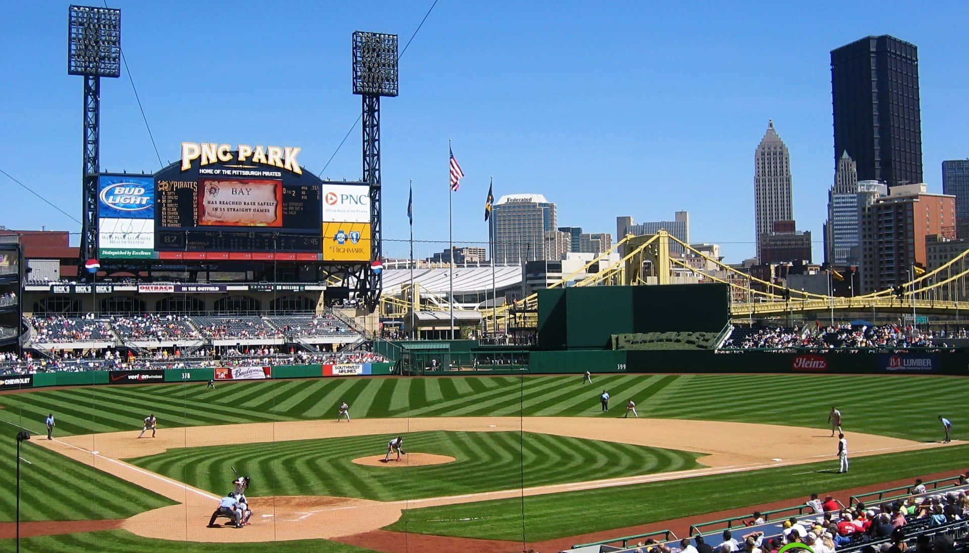 A Stunning Panoramic View Of A Baseball Stadium Under The Night Sky. Wallpaper