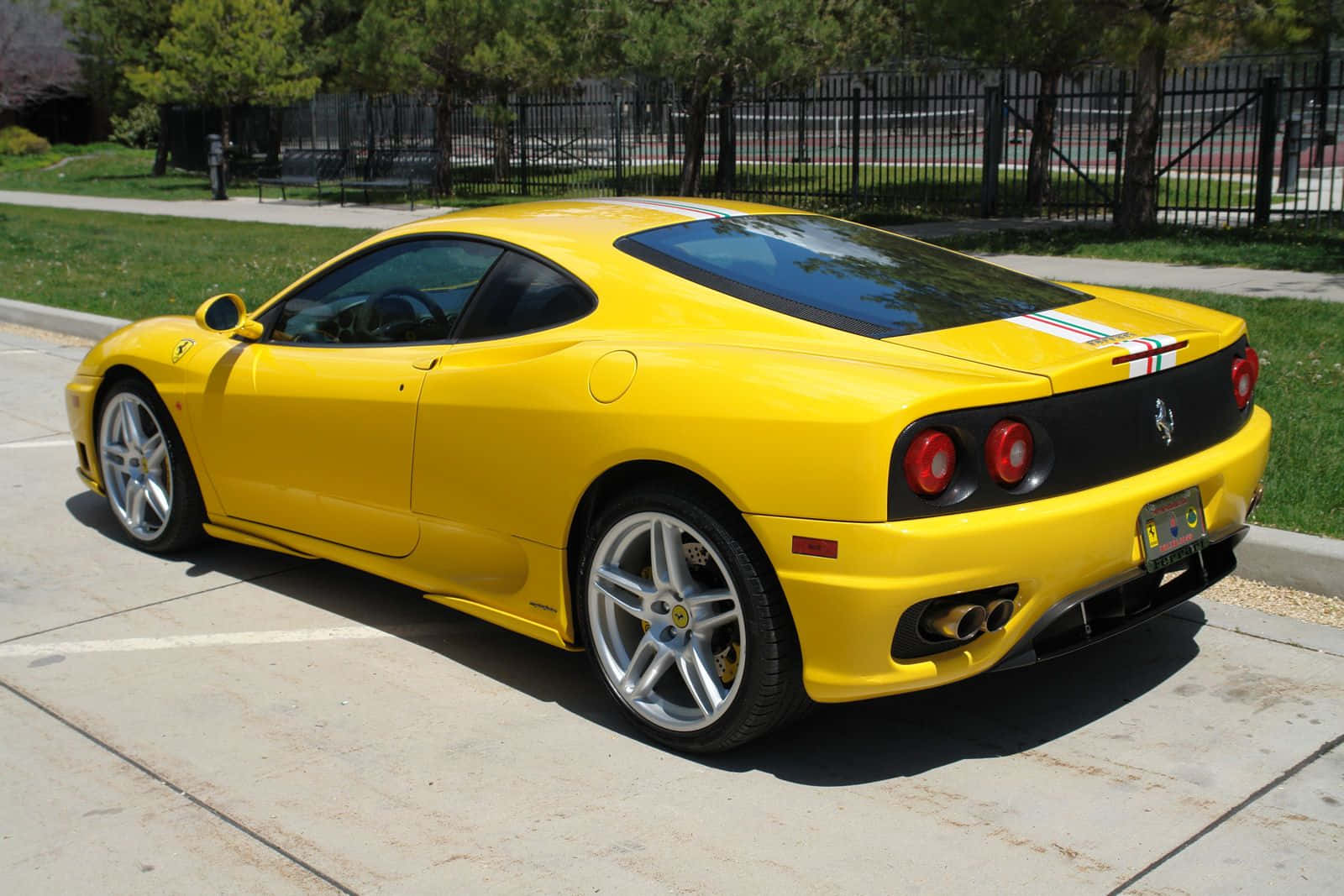 A Stunning Red Ferrari 360 Modena Showcased On The Road Wallpaper