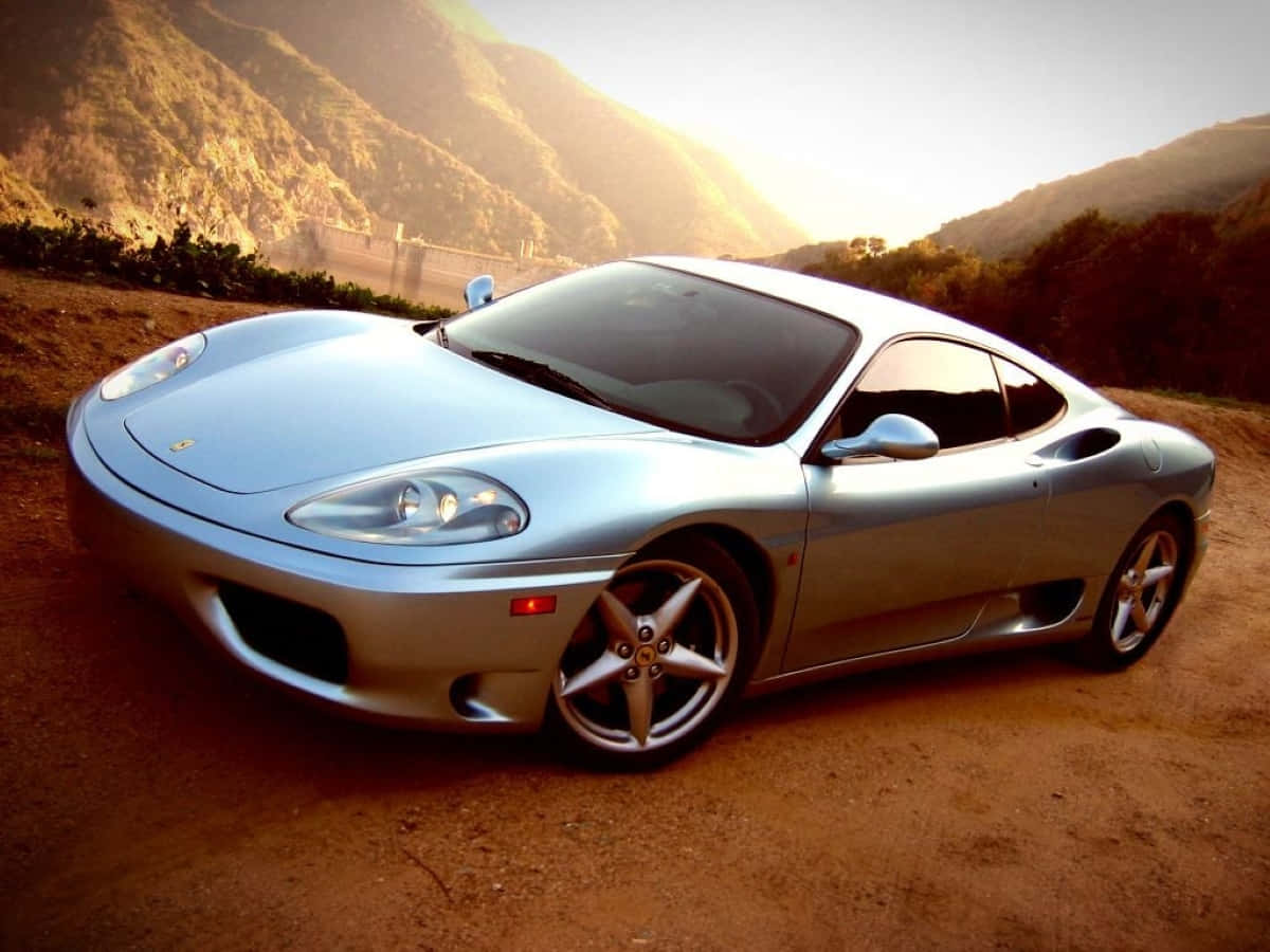 A Stunning Red Ferrari 360 Modena Showcasing Its Elegant Design On An Open Road. Wallpaper