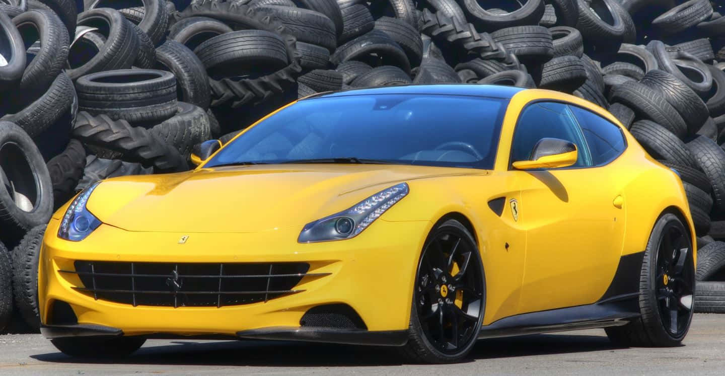 A Stunning Red Ferrari Ff On An Open Road Wallpaper