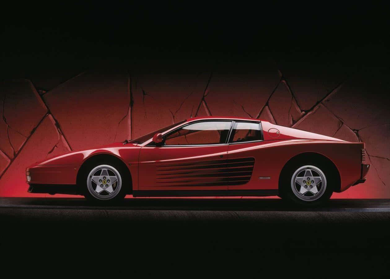 A Stunning Red Ferrari Testarossa Parked Outdoors Wallpaper