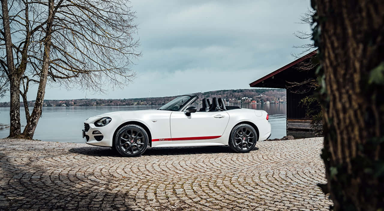 A Stunning Red Fiat 124 Spider Wallpaper